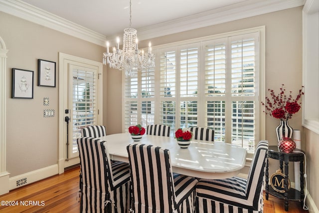 dining space featuring an inviting chandelier, crown molding, and light wood-type flooring