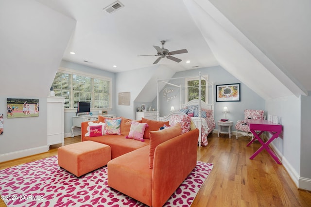 living room featuring light hardwood / wood-style flooring, ceiling fan, and vaulted ceiling