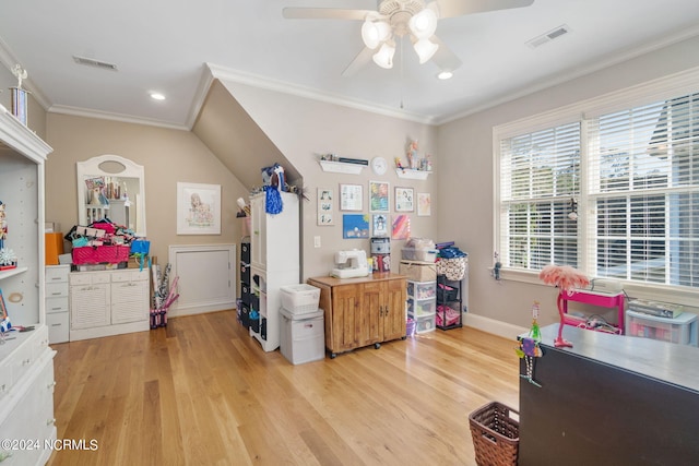 interior space with crown molding, ceiling fan, and light hardwood / wood-style floors