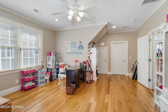 rec room with crown molding, ceiling fan, and wood-type flooring