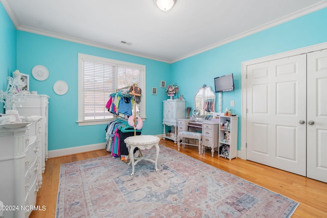 recreation room with crown molding and hardwood / wood-style floors