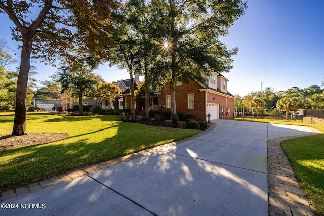 view of front of house with a garage and a front lawn