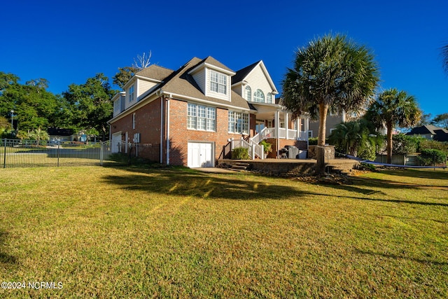 rear view of property featuring a lawn