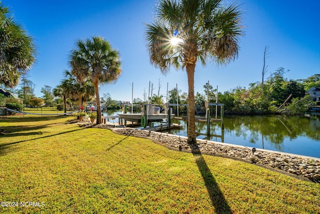 view of dock featuring a water view and a lawn