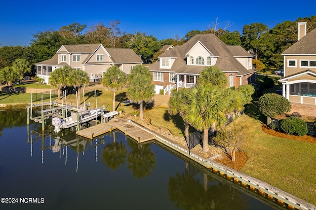 exterior space with a water view and a lawn