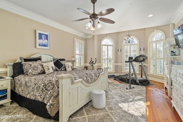 bedroom featuring ornamental molding and hardwood / wood-style floors