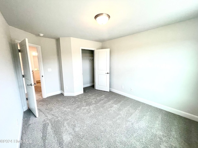 unfurnished bedroom with carpet floors, baseboards, and a closet