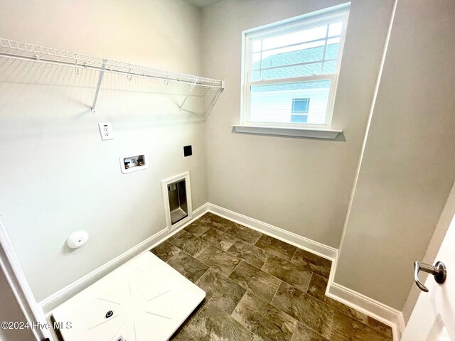 laundry room featuring stone finish floor, laundry area, hookup for a washing machine, and baseboards