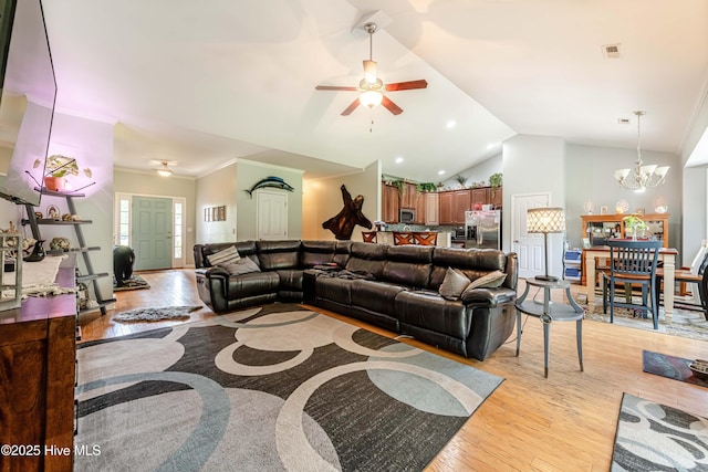 220 Everett Yopp Dr, Sneads Ferry, NC 28460 - living room with ceiling fan, vaulted ceiling, light wood finished floors, a chandelier, and crown molding