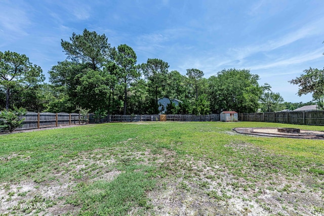 220 Everett Yopp Dr, Sneads Ferry, NC 28460 - fenced backyard with an outdoor fire pit and a shed