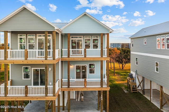 rear view of property with cooling unit and a carport