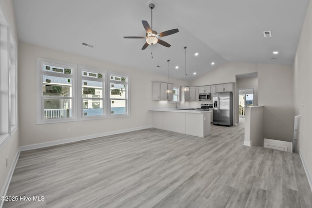 kitchen featuring appliances with stainless steel finishes, kitchen peninsula, ceiling fan, white cabinetry, and decorative light fixtures