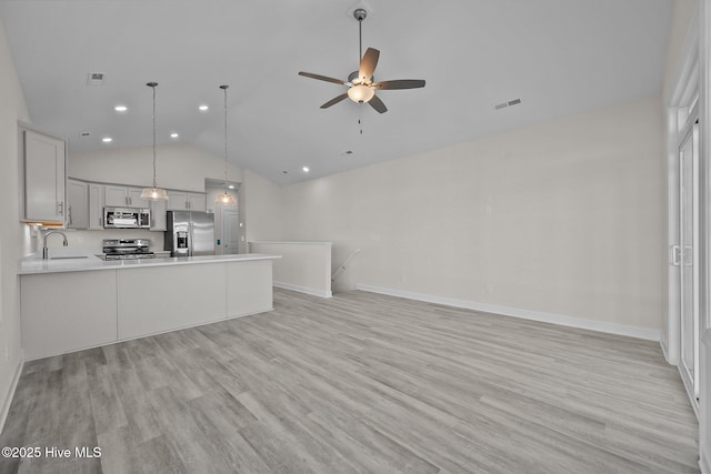 kitchen with stainless steel appliances, hanging light fixtures, kitchen peninsula, ceiling fan, and sink