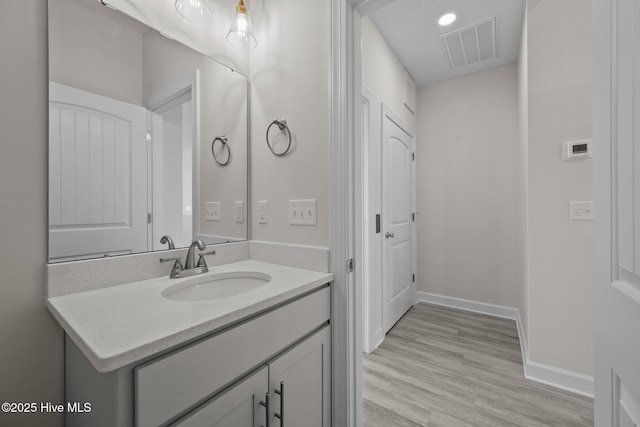 bathroom featuring vanity and hardwood / wood-style floors