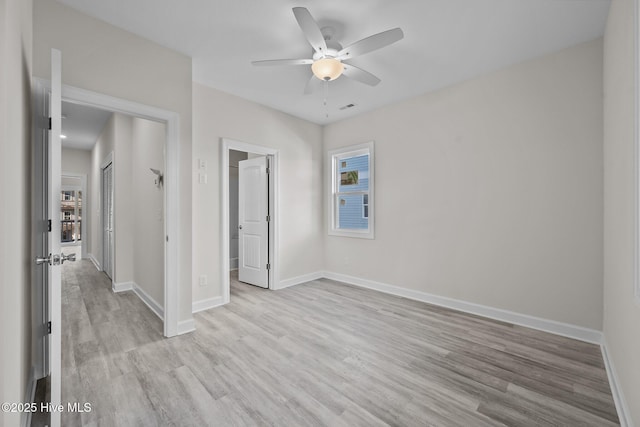 unfurnished bedroom with ceiling fan, light hardwood / wood-style flooring, and a closet