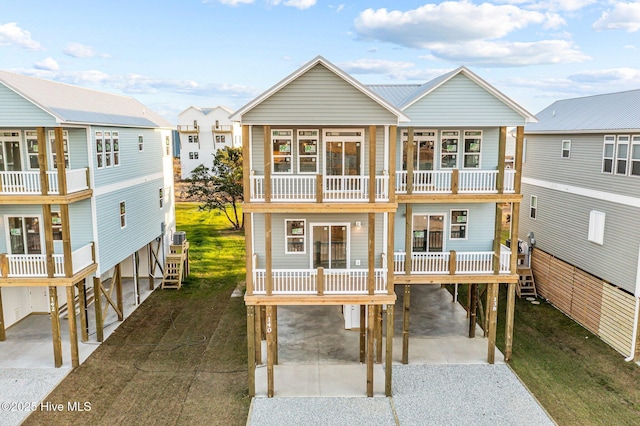 view of front of home with a balcony, covered porch, and a carport