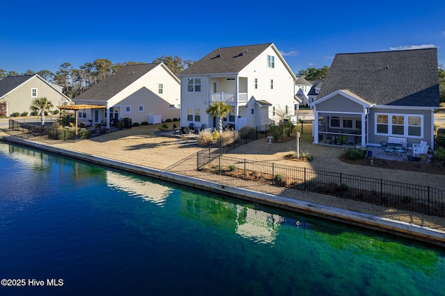 rear view of house with a fenced in pool, a balcony, a pergola, and a patio