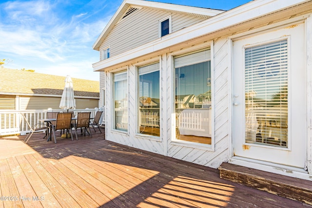 27 Newport St, Ocean Isle Beach, NC 28469 - wooden terrace featuring outdoor dining area