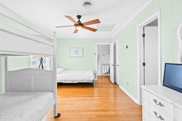 27 Newport St, Ocean Isle Beach, NC 28469 - bedroom featuring crown molding, light wood finished floors, and ceiling fan