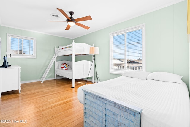 bedroom featuring wood-type flooring, ceiling fan, and crown molding