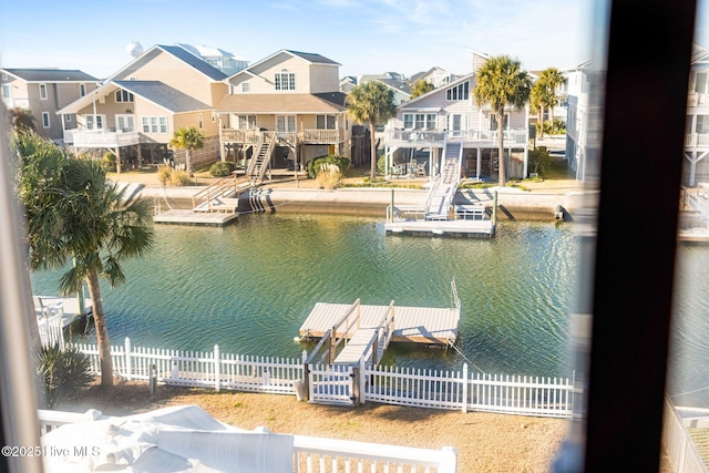 27 Newport St, Ocean Isle Beach, NC 28469 - dock area featuring a water view, fence, and a residential view