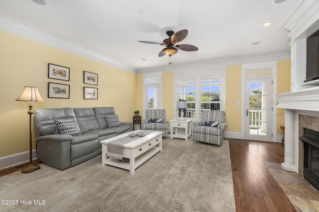 116 Salter Path Rd Unit 102Seabrook, Pine Knoll Shores, NC 28512 - living room with a tiled fireplace, ceiling fan, ornamental molding, wood-type flooring, and baseboards