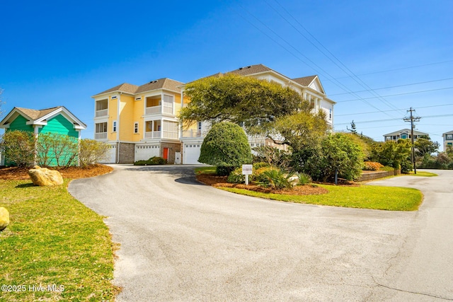 116 Salter Path Rd Unit 102Seabrook, Pine Knoll Shores, NC 28512 - view of front of home with asphalt driveway and a garage