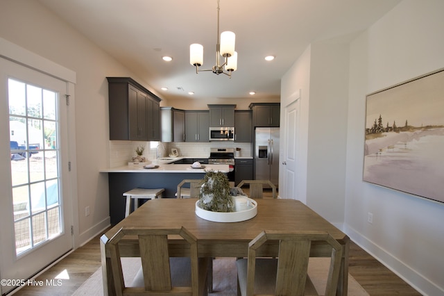 810 Red Sky Dr NE, Leland, NC 28479 - dining area with recessed lighting, baseboards, an inviting chandelier, and light wood-style floors