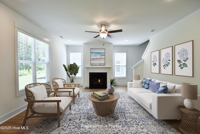 810 Red Sky Dr NE, Leland, NC 28479 - living area with a fireplace with flush hearth, baseboards, visible vents, wood finished floors, and ceiling fan
