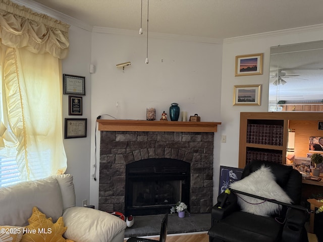living area with a ceiling fan, ornamental molding, wood finished floors, and a fireplace