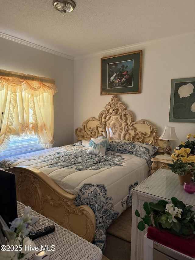 bedroom featuring crown molding and a textured ceiling