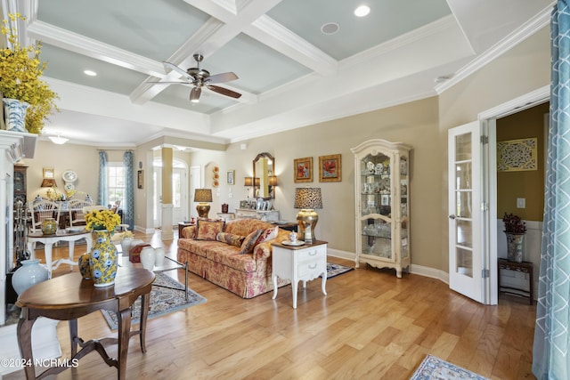 living room with ceiling fan, coffered ceiling, beamed ceiling, decorative columns, and crown molding