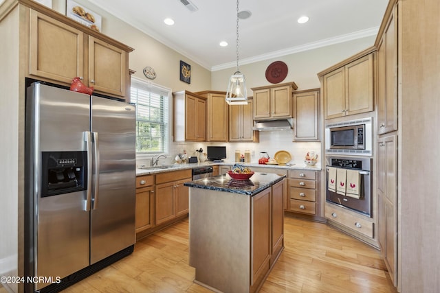 kitchen featuring hanging light fixtures, backsplash, appliances with stainless steel finishes, a kitchen island, and ornamental molding