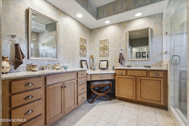 bathroom with tile patterned floors, vanity, and a shower with door