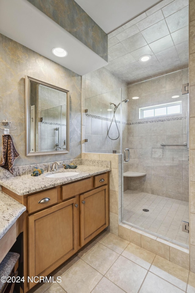 bathroom with vanity, tile patterned floors, and an enclosed shower