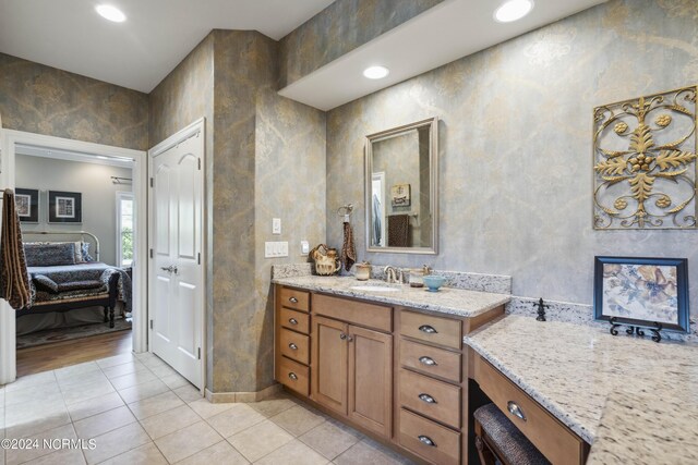 bathroom featuring tile patterned flooring and vanity