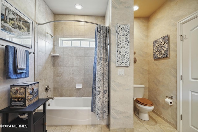 bathroom featuring tile patterned flooring, toilet, and shower / bathtub combination with curtain