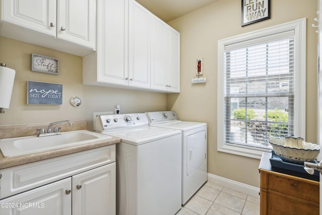 laundry area featuring cabinets, independent washer and dryer, sink, and light tile patterned floors