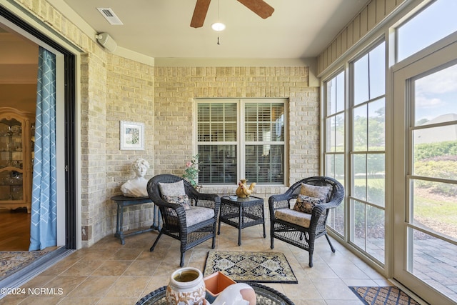 sunroom featuring ceiling fan