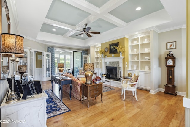 living room with coffered ceiling, crown molding, light hardwood / wood-style flooring, built in features, and beamed ceiling