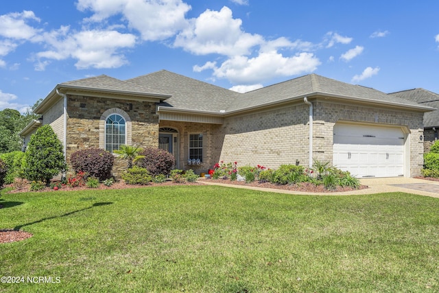 view of front of home with a garage and a front lawn