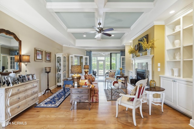 interior space with beam ceiling, ceiling fan, coffered ceiling, and light wood-type flooring