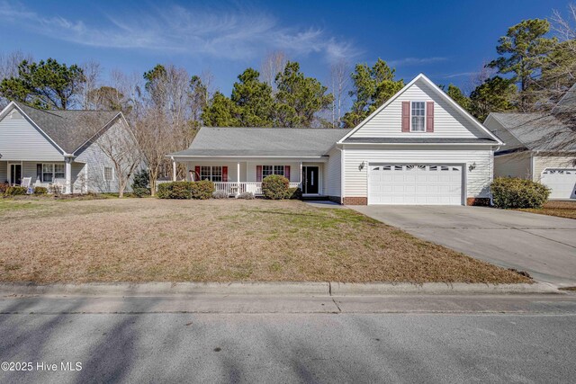 view of front facade with a garage, covered porch, and a front yard