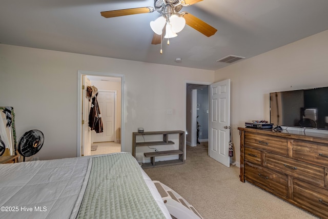 carpeted bedroom featuring a closet, a spacious closet, and ceiling fan