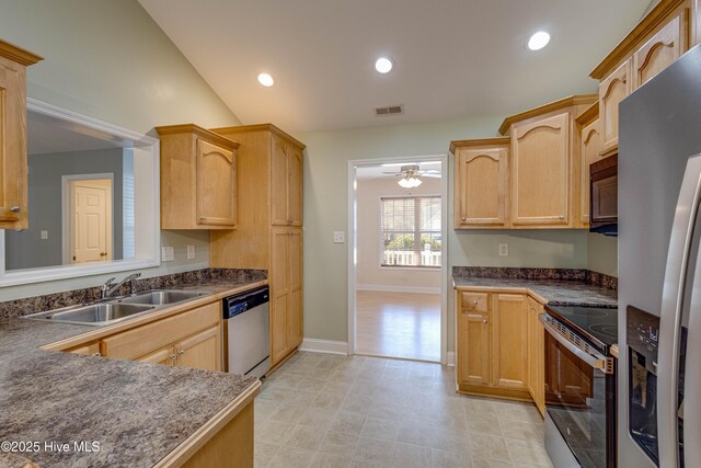 kitchen with ceiling fan, dishwasher, vaulted ceiling, and sink