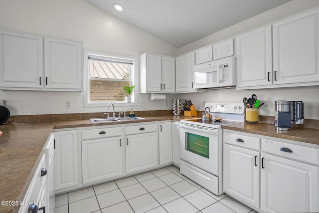 kitchen featuring white cabinets, white appliances, vaulted ceiling, and sink