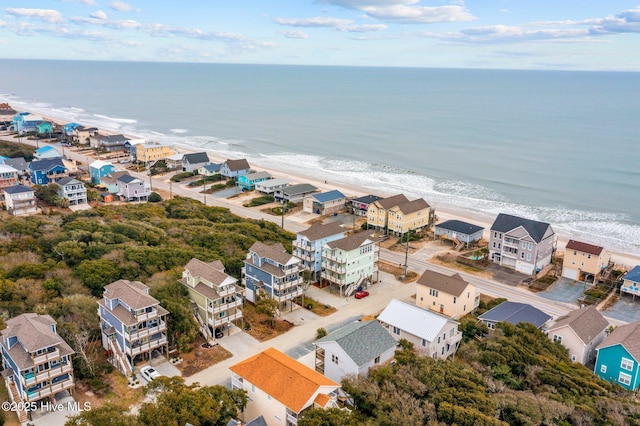 birds eye view of property featuring a water view and a view of the beach