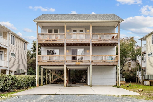 view of front of property with cooling unit and a carport