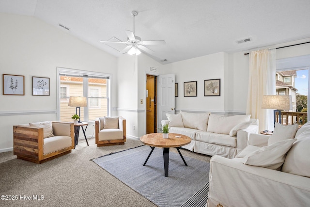 living room featuring ceiling fan, carpet floors, and lofted ceiling