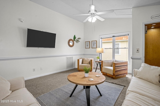 carpeted living room featuring ceiling fan and vaulted ceiling